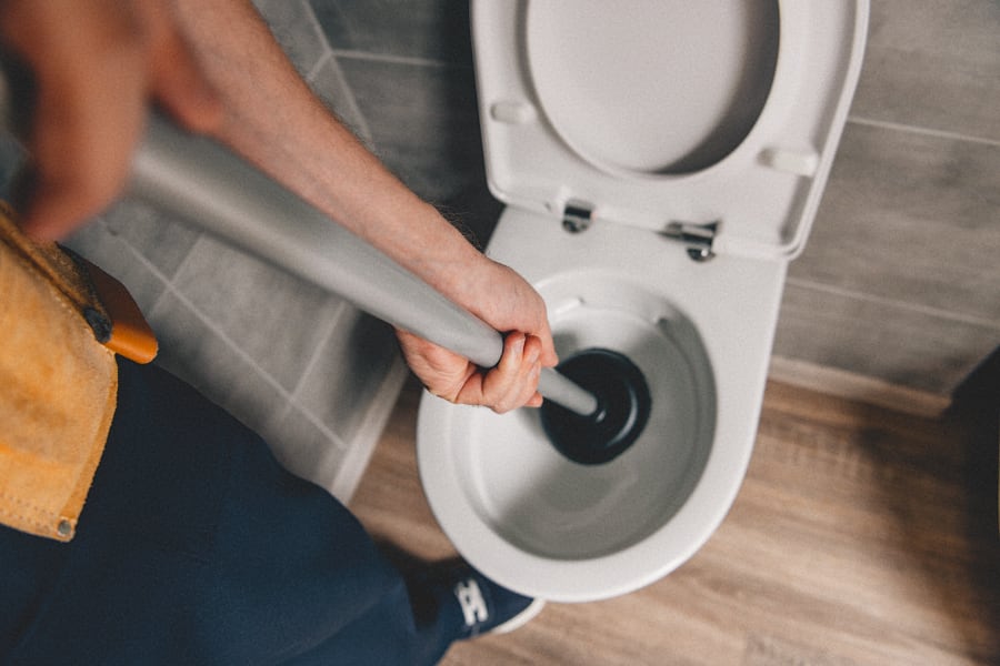 unclogging toilet with plunger